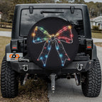 Christmas Lights Bow tire cover product photo of festive multicolor light bow on solid black backdrop