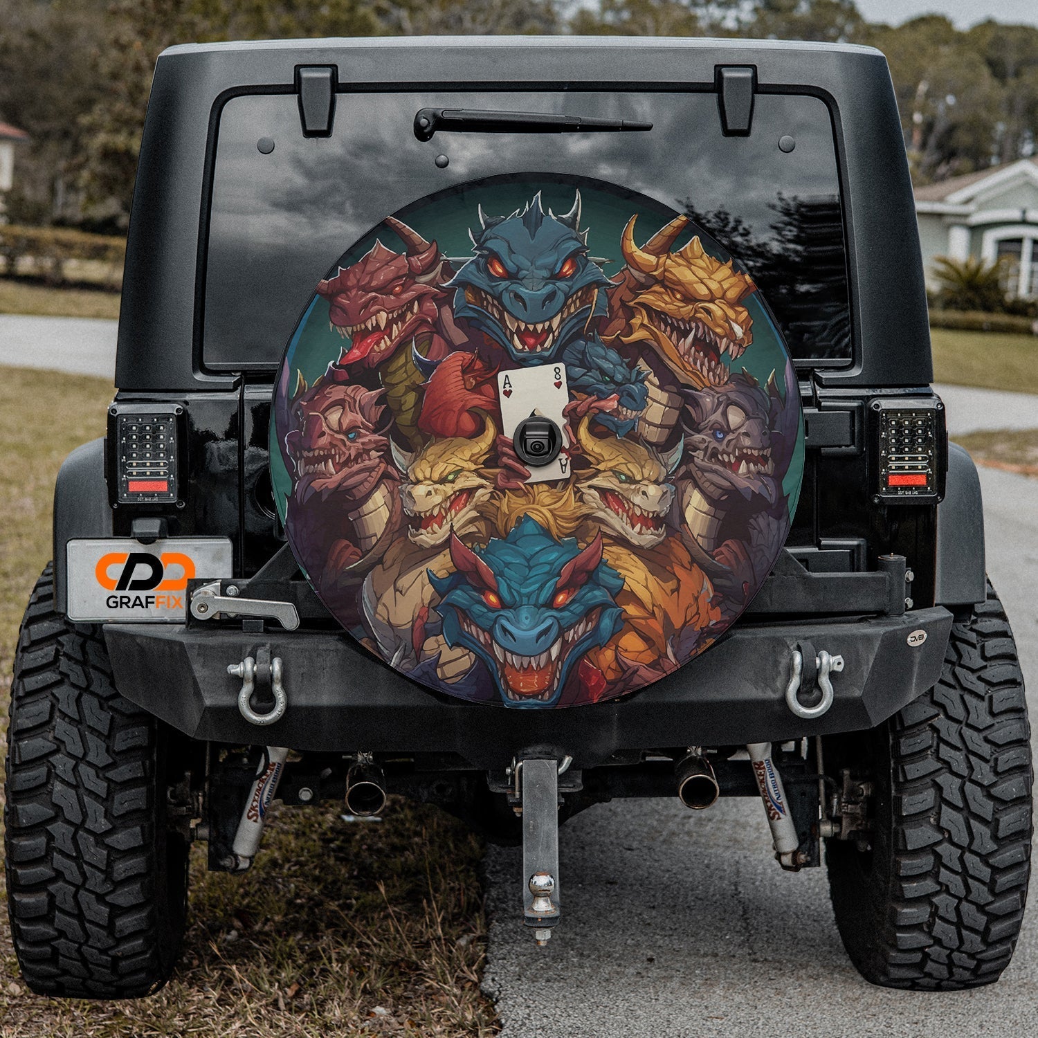 Black Jeep Wrangler with dragon ace mischief tire cover showcasing fierce multi colored dragon heads