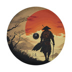 Samurai sunset tire cover mounted on red Jeep Wrangler showing camera cutout next to walking warrior figure