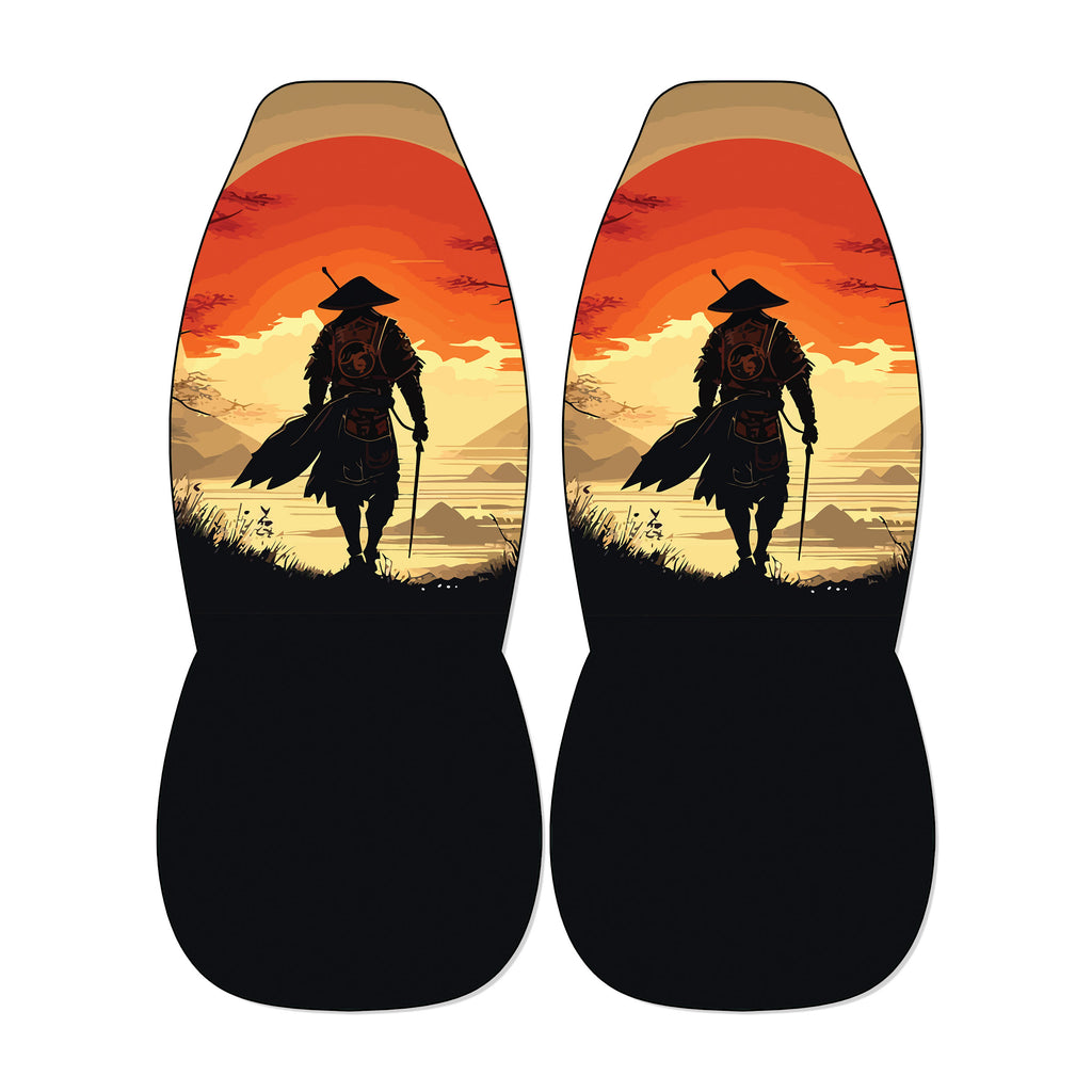 a pair of black seat covers with a design depicting a silhouetted figure of a person walking against a sunset landscape.