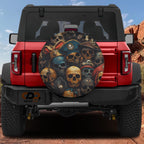 Pirate skulls spare tire cover on red Ford Bronco with stacked weathered skulls in tricorn pirate hats