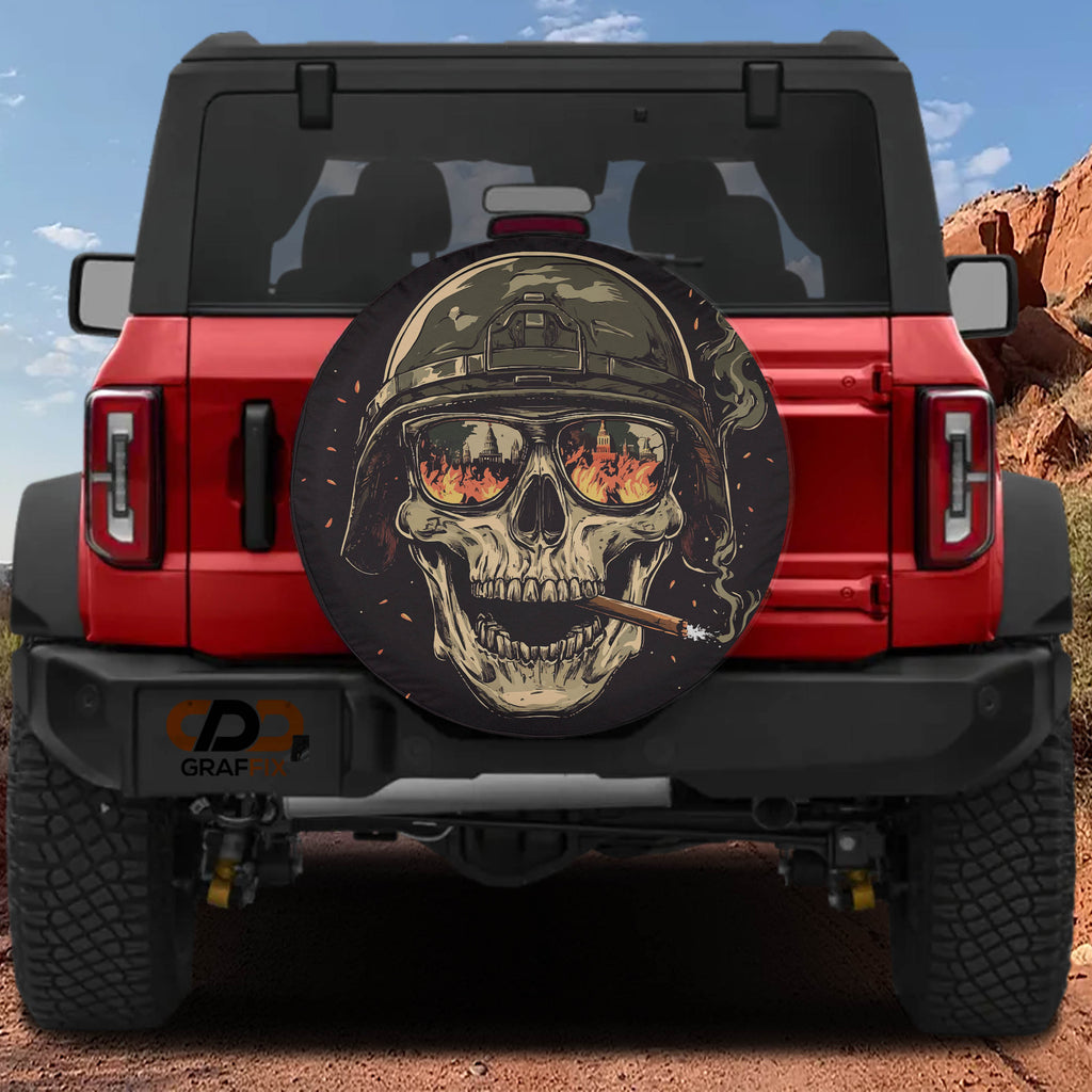 Burning reflections army skull spare tire cover on a black Jeep Wrangler with GRAFFIX bumper sticker