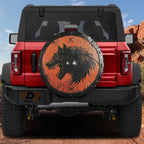 Viking Fenrir wolf shield spare tire cover on red Ford Bronco rustic orange wood and black ironwork