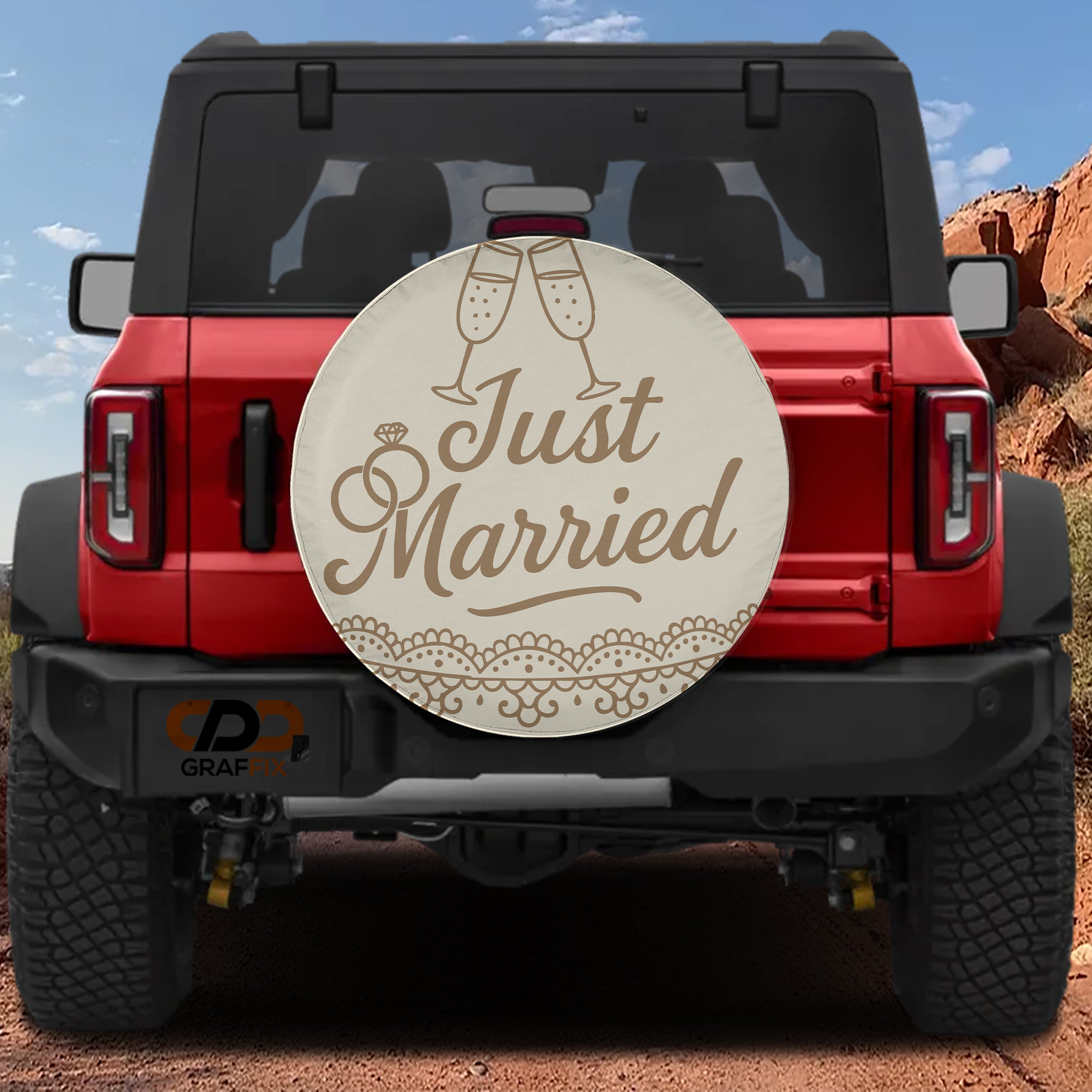 Just Married spare tire cover on red Ford Bronco with champagne flutes ring script design