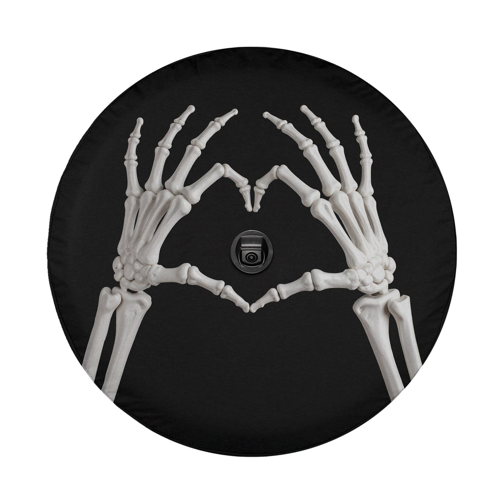 A skeleton hand forming a heart shape on a black background.