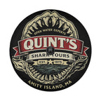 a circular logo with a shark's head design and text, including the name of the business.