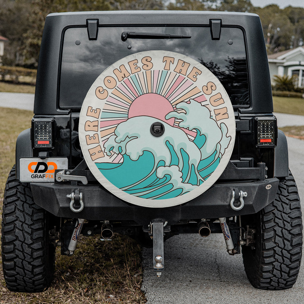 Here Comes the Sun spare tire cover on red Bronco rear with boho sun and crashing waves