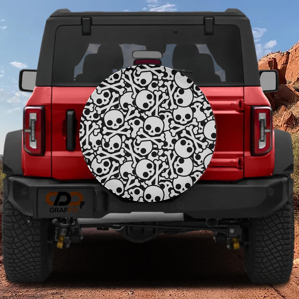 Skull and crossbones tire cover on red Ford Bronco with cartoon black-and-white skulls and bone pile pattern
