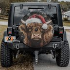 Highland cow with Santa hat spare tire cover displayed on the rear of a Jeep Wrangler tailgate