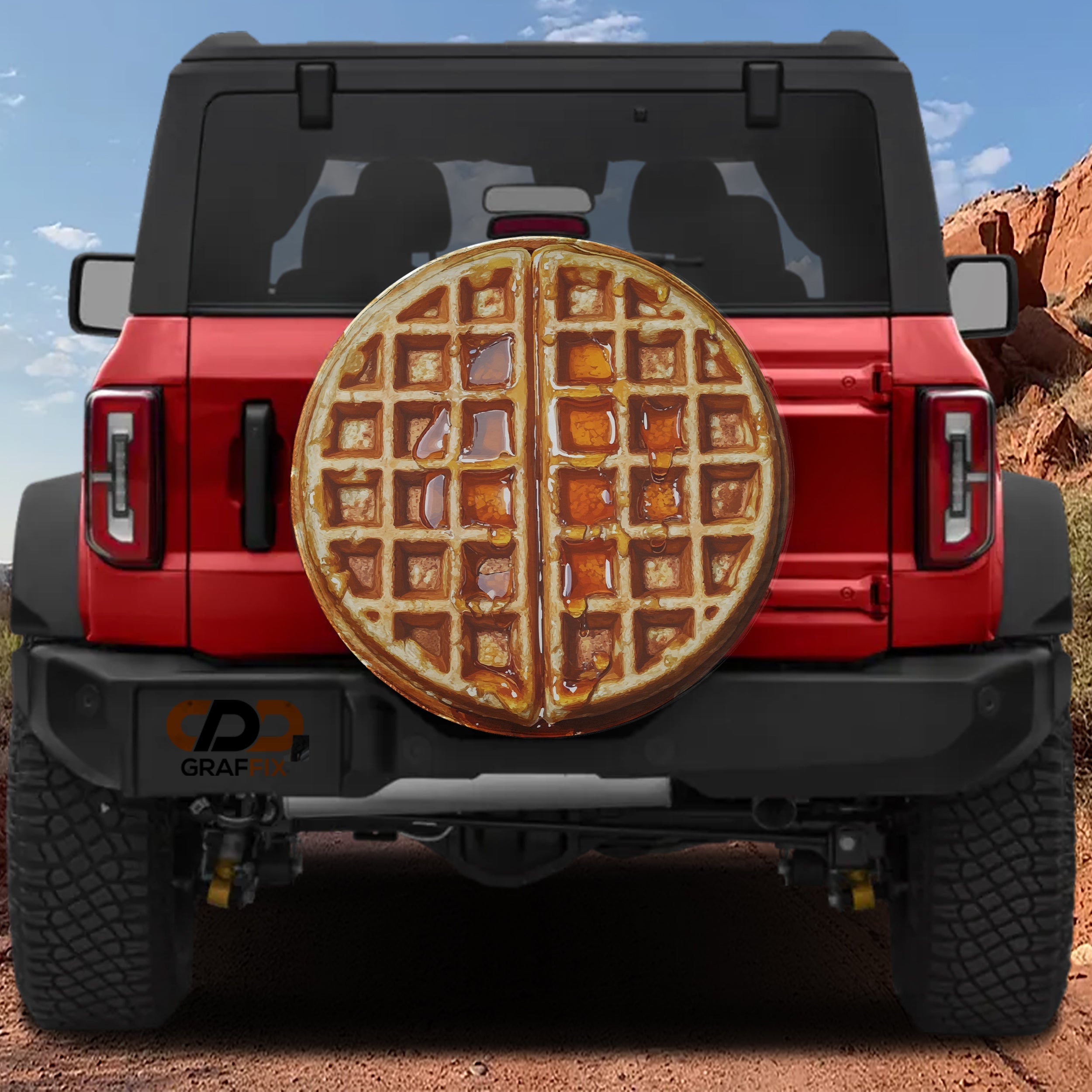 Maple syrup Belgian waffle spare tire cover rear angle view on parked Jeep Wrangler