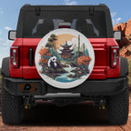 A red Jeep Wrangler with a large, decorative wheel cover featuring a panda bear and a scenic landscape.