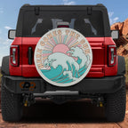 Here Comes the Sun spare tire cover on red Ford Bronco with retro pink sun and teal waves