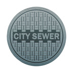 Sewer manhole cover spare tire cover installed on rear of Jeep vehicle