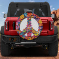 Red Bronco at desert featuring floral daisy peace symbol spare tire cover with vibrant colored petals