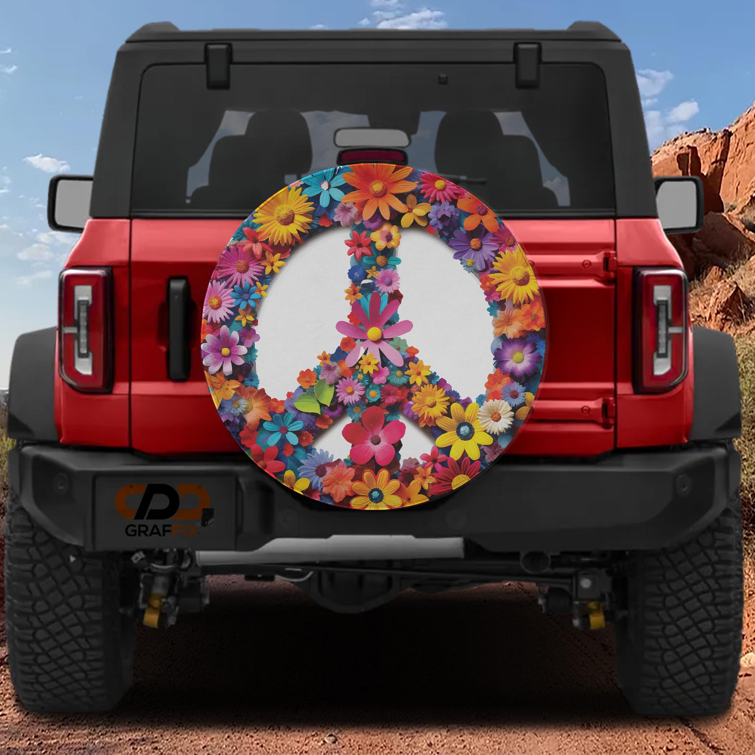 Red Bronco at desert featuring floral daisy peace symbol spare tire cover with vibrant colored petals