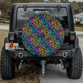 Leopard rainbow print spare tire cover mounted on red Ford Bronco rear in desert setting