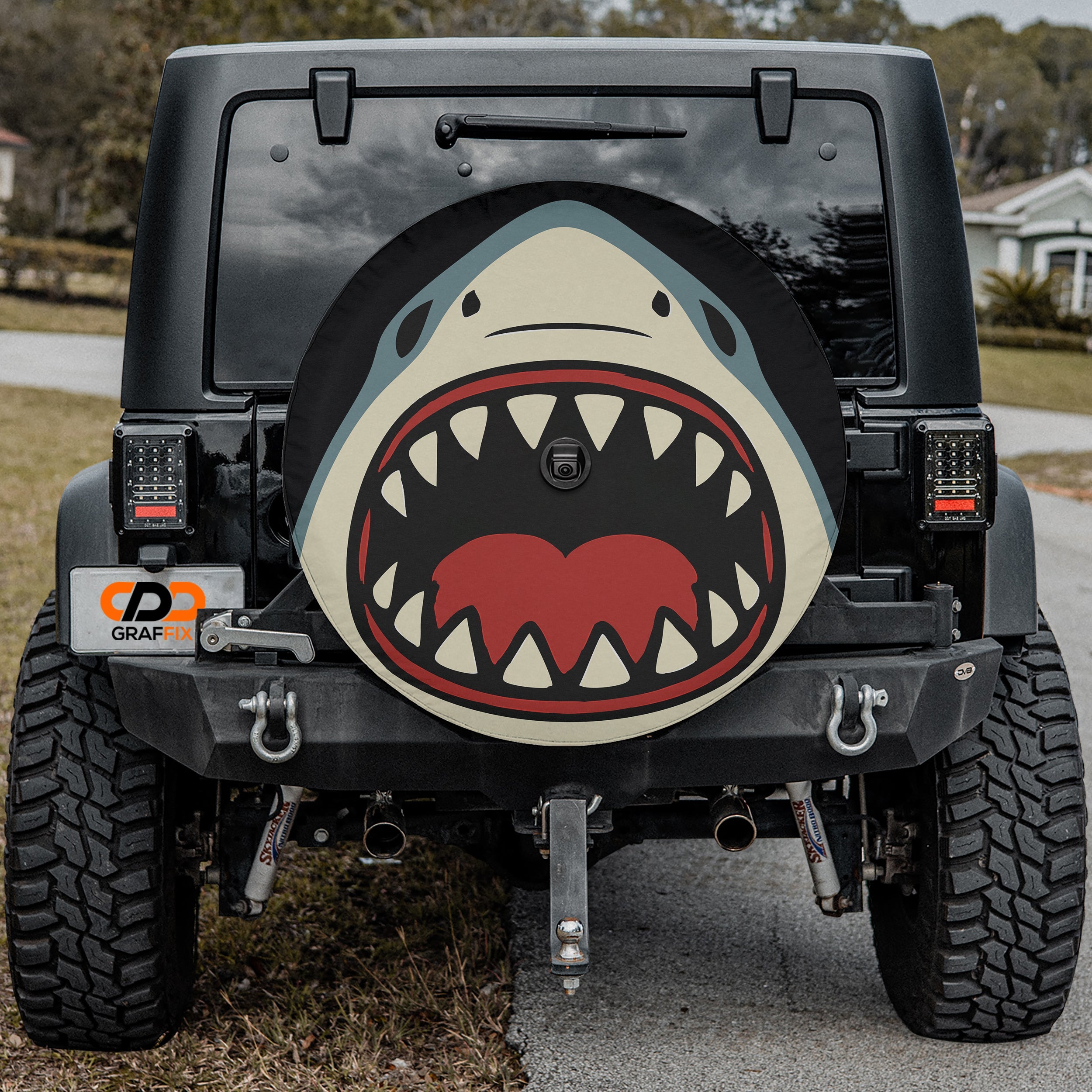 Shark Bite spare tire cover on red Bronco rear with cartoon shark biting graphic