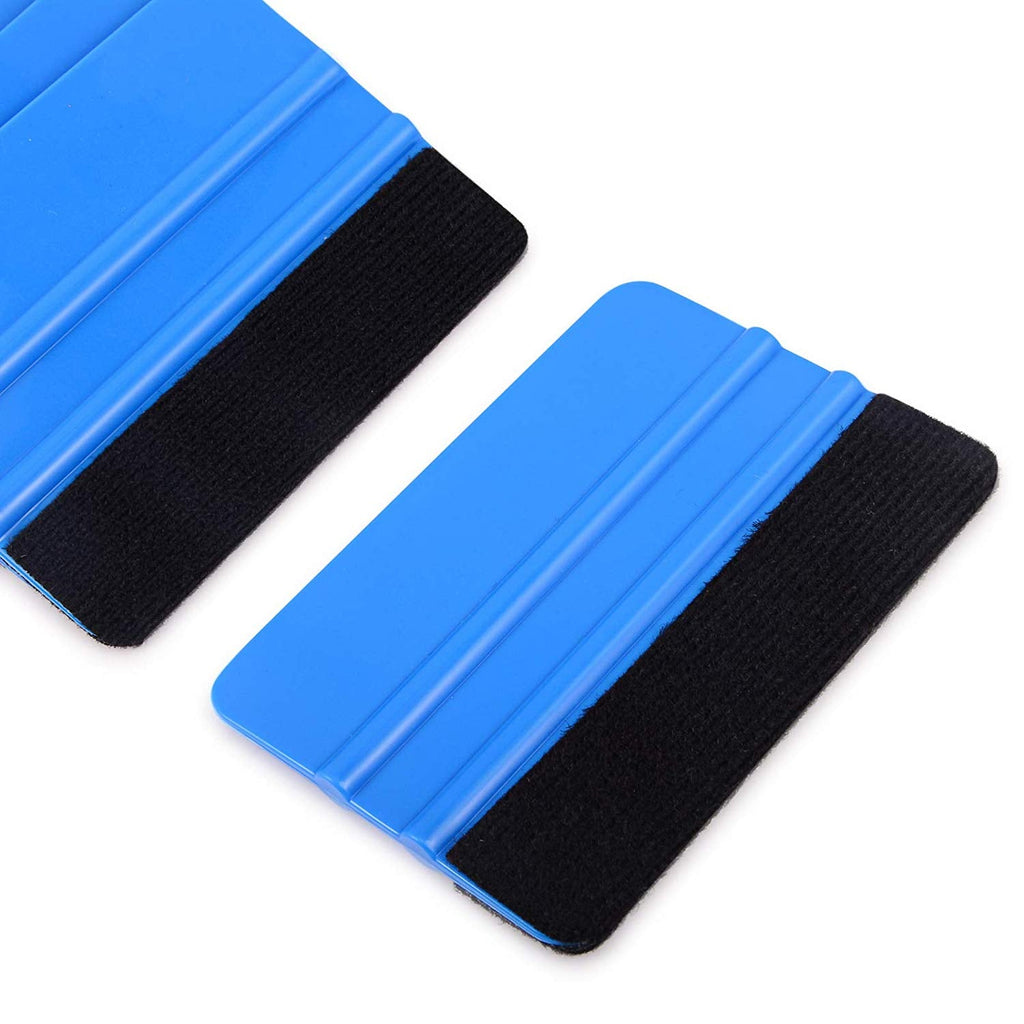 Gloved hand using blue felt edge squeegee 4 inch decal applicator tool on black carbon vinyl wrap