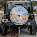 a black Jeep Wrangler with a large Easter-themed wheel cover attached to the rear.