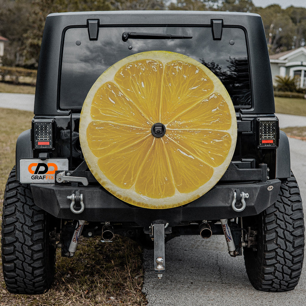 Lemon fruit spare tire cover with yellow citrus slice graphic and juicy sliced lemon design