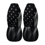 two black car seat covers with a pattern of white stars on a black background.