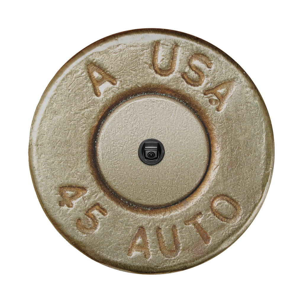 a close-up of a bullet casing with embossed text and a small black object in the center.