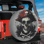 Pirate skull spare tire cover with red hat installed on red Jeep Wrangler with rocky desert behind