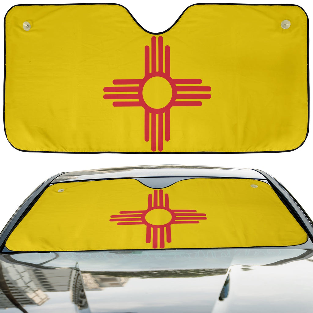 New Mexico State Flag accordion sunshade installed in a sedan windshield on a sunny urban city street view
