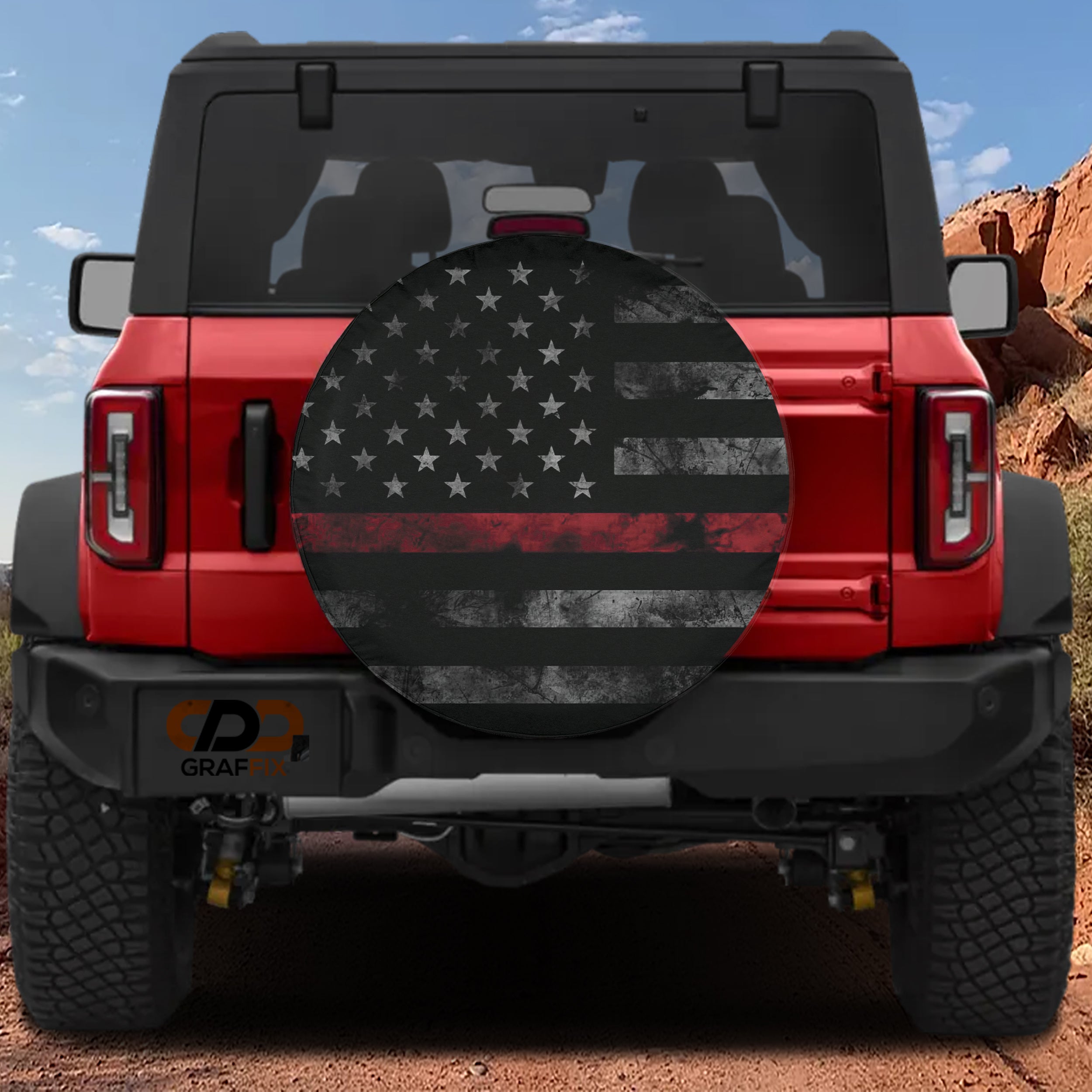 Thin Red Line Subdued American Flag spare tire cover on a red Jeep Wrangler with subdued flag artwork across the cover