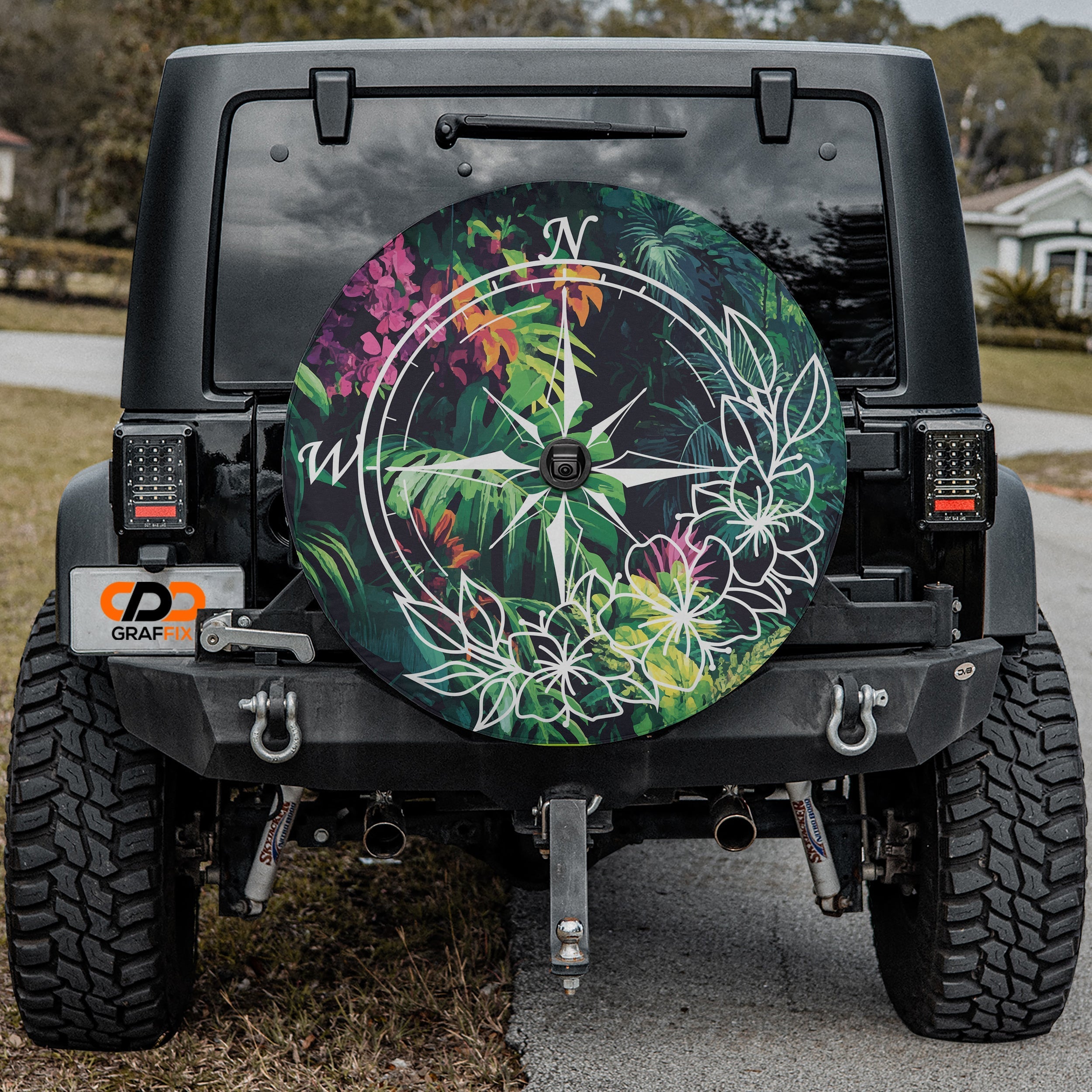 Tropical Compass Adventure spare tire cover with jungle compass design mounted on Jeep vehicle