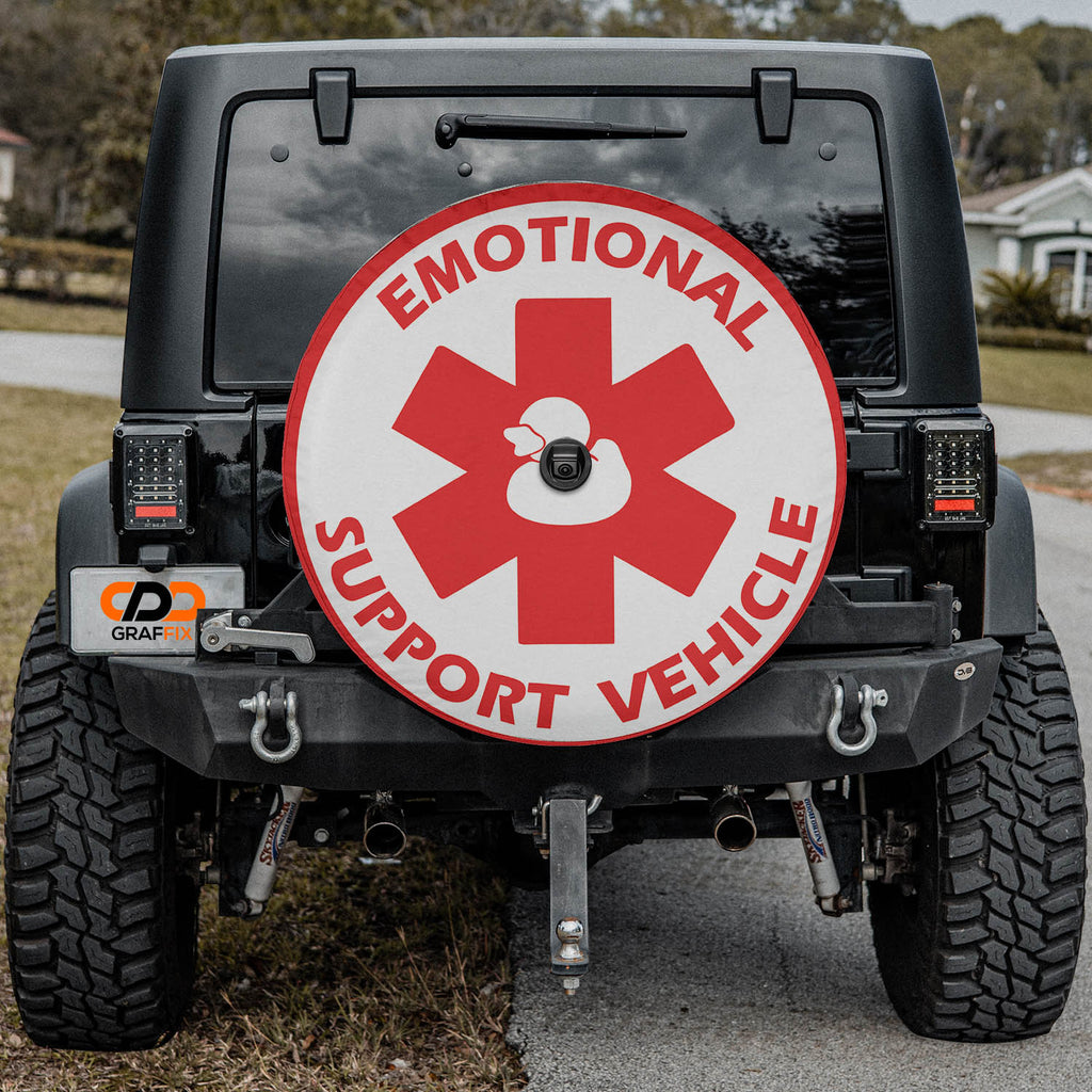 Emotional Support Duck red and white medical cross tire cover on red Ford Bronco rear with rocks