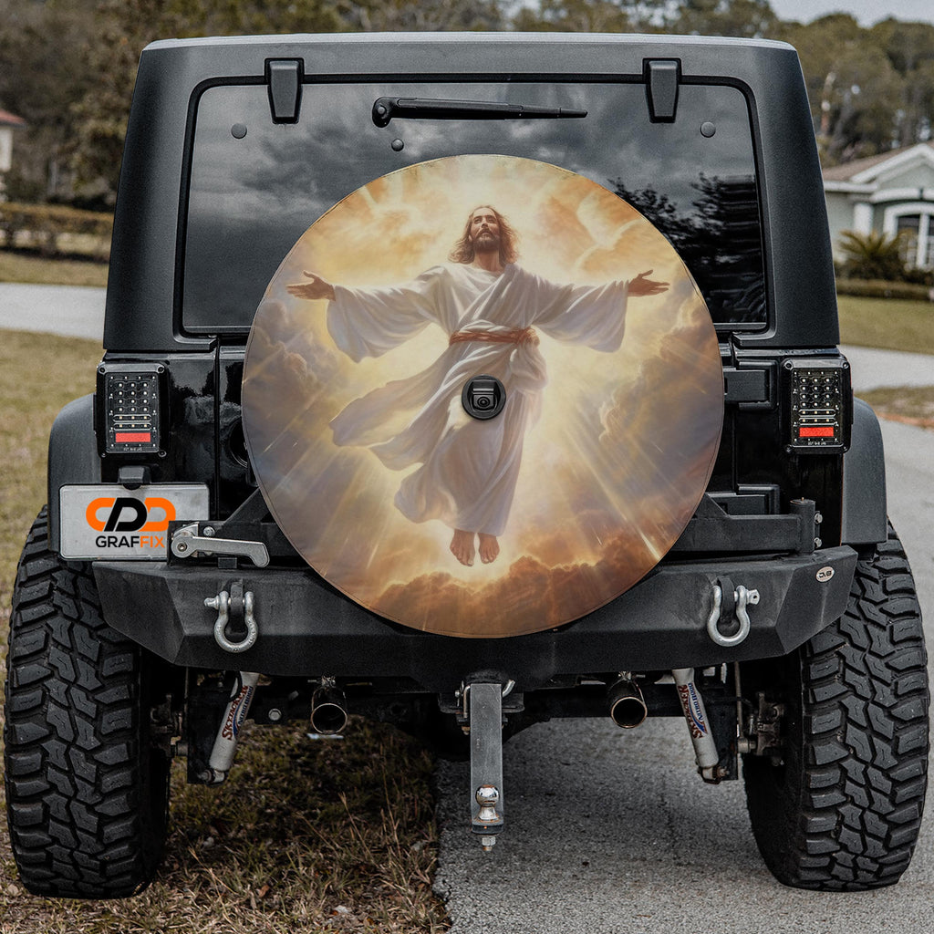 a black Jeep Wrangler with a large chrome wheel cover featuring a painting of Jesus Christ.
