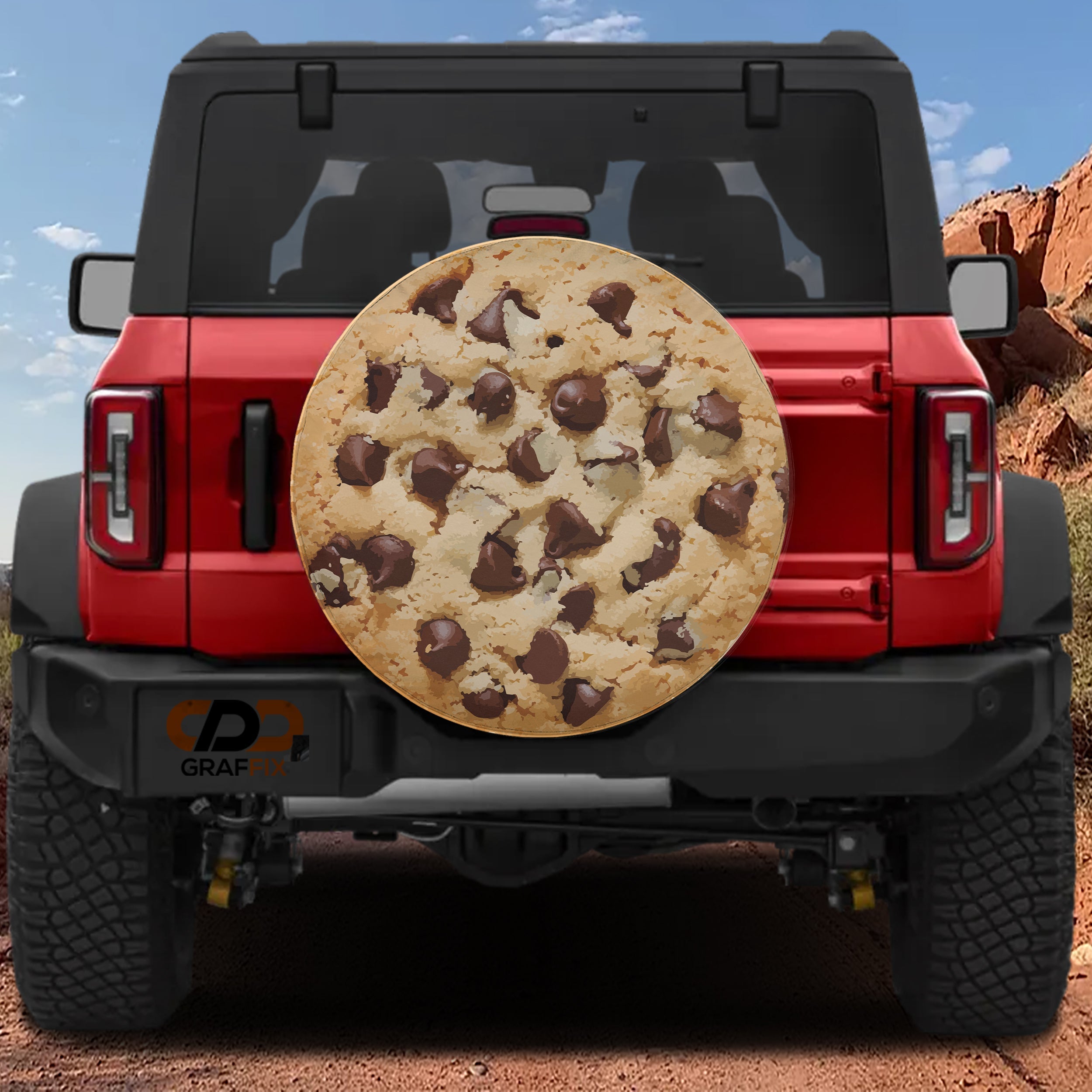 Chip Chip Hooray spare tire cover on a red Jeep Wrangler showing the chocolate chip cookie illustration on the rear