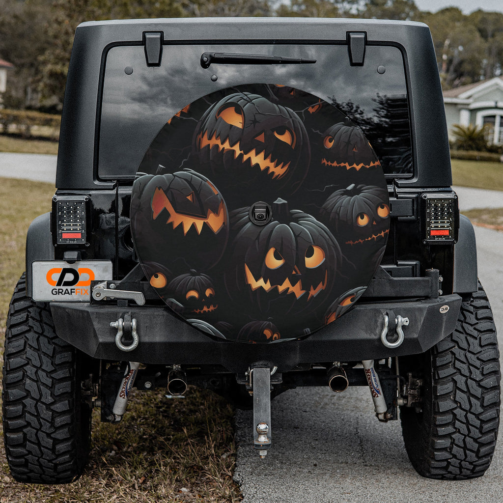 Halloween Shadow Pumpkin Patch spare tire cover with spooky pumpkins mounted on Jeep tailgate