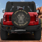 a red Jeep Wrangler with a large lion head decal on the rear window.