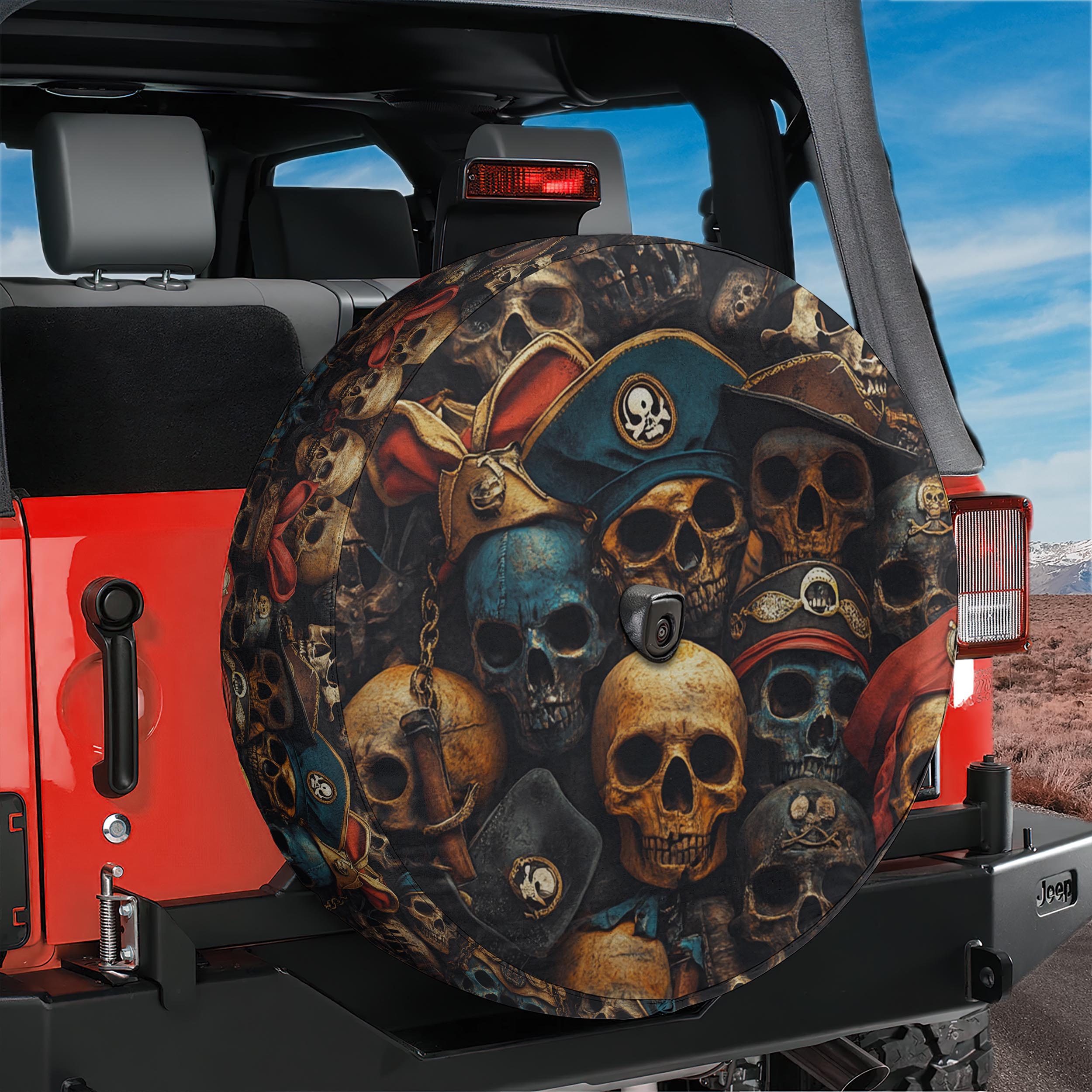 Pirate skulls tire cover on red Jeep Wrangler with weathered skulls in vintage pirate hats and bandanas
