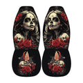 a pair of black and white car seat covers with a skull design and floral elements.