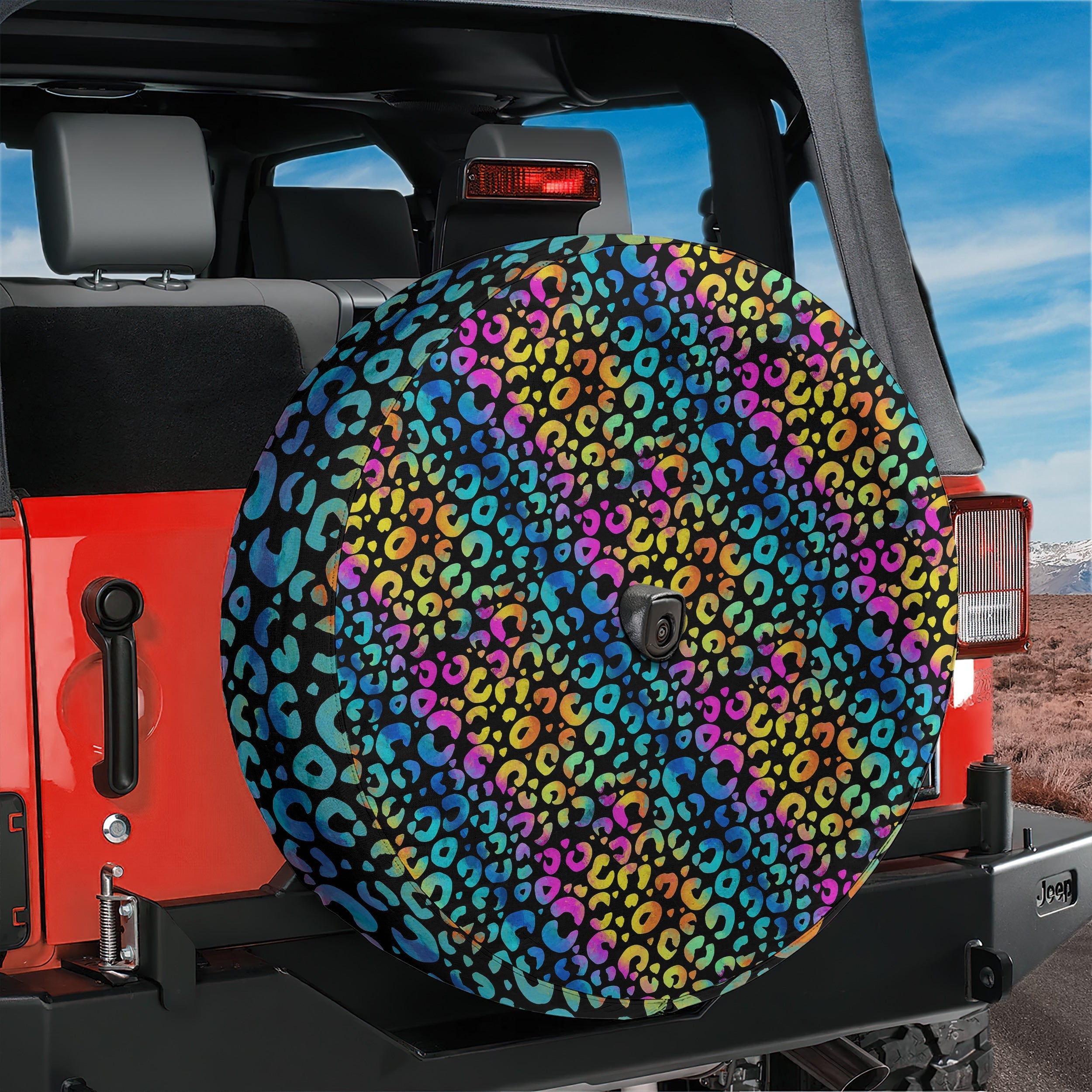 Leopard rainbow print spare tire cover front view on black Jeep Wrangler with backup camera hole