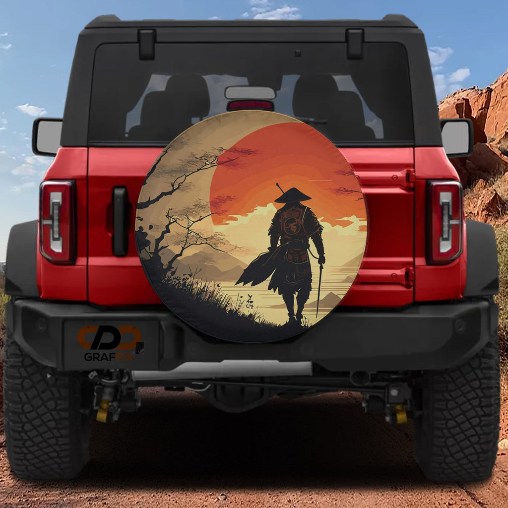 Samurai sunset spare tire cover on red Ford Bronco rear showing warrior silhouette against orange Japanese sun