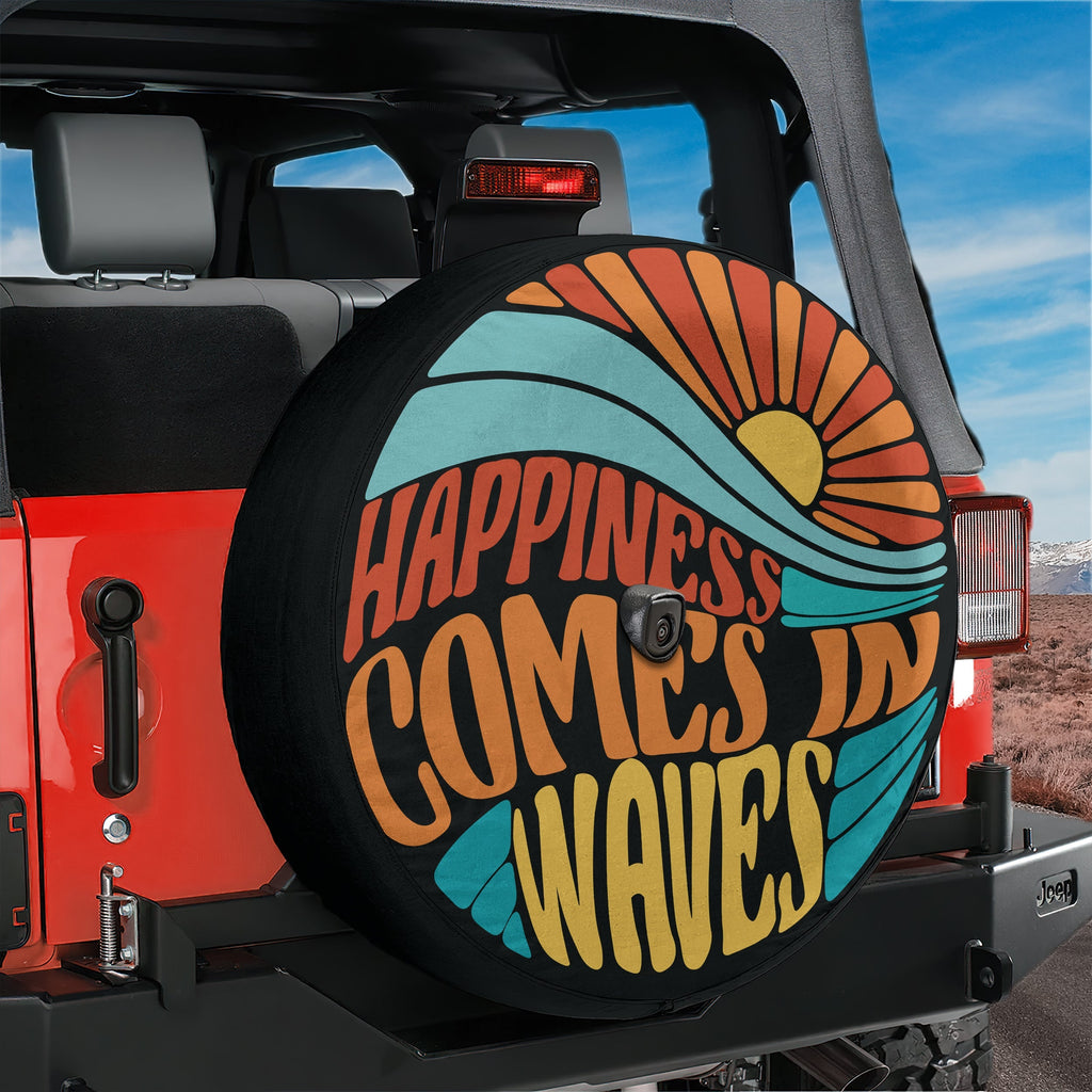 A colorful wheel cover with the text "Happiness comes in waves" printed on it, attached to the rear of a red Jeep.