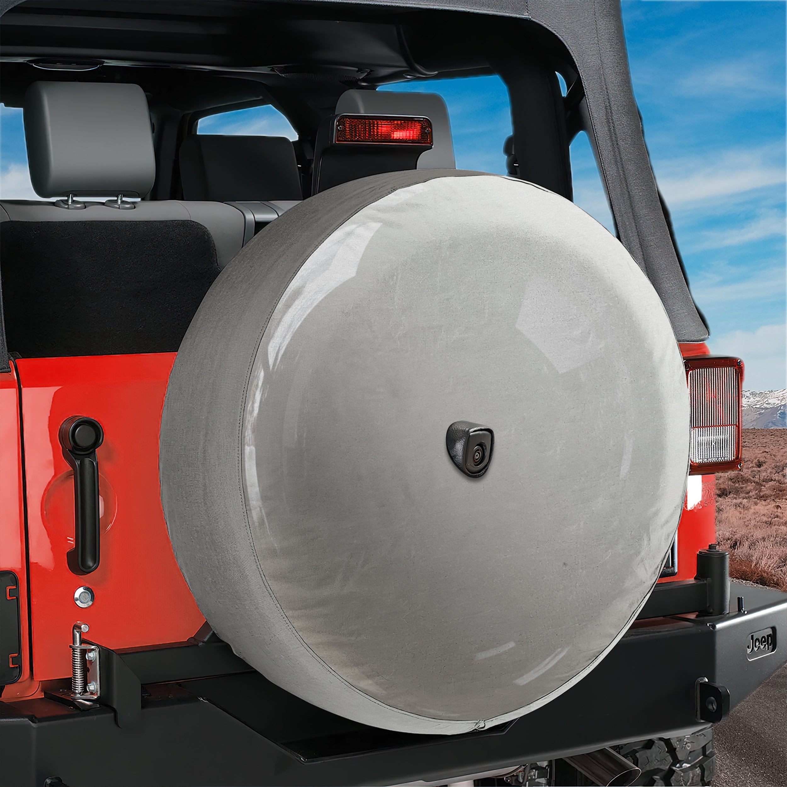 A red Jeep Wrangler with a spare tire mounted on the rear of the vehicle.