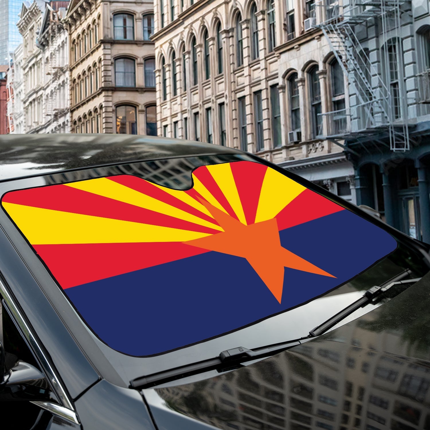 Arizona flag sunrays and copper star windshield sunshade mounted in a sedan on a sunny city street