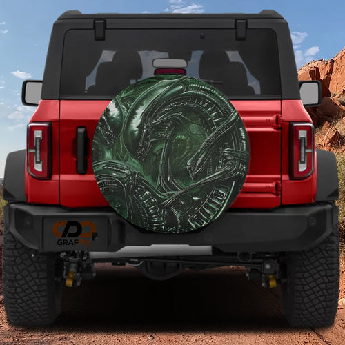 Alien lifeform spare tire cover featuring green H.R. Giger style xenomorph biomechanical artwork detail