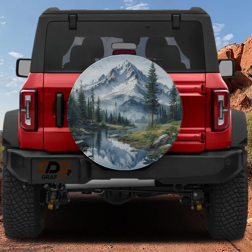 a red Jeep Wrangler with a large, round spare tire cover that displays a scenic mountain landscape.