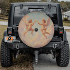 Angels' Toast spare tire cover with cherubs design mounted on black Jeep Wrangler tailgate