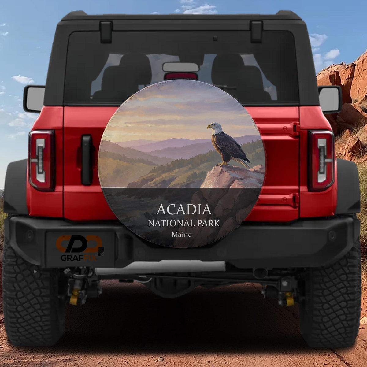 Acadia National Park spare tire cover without a camera cutout, mounted on a red Ford Bronco in red rock country