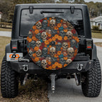 Flowers and skulls tire cover on black Jeep Wrangler with orange marigolds, red roses, and weathered skulls