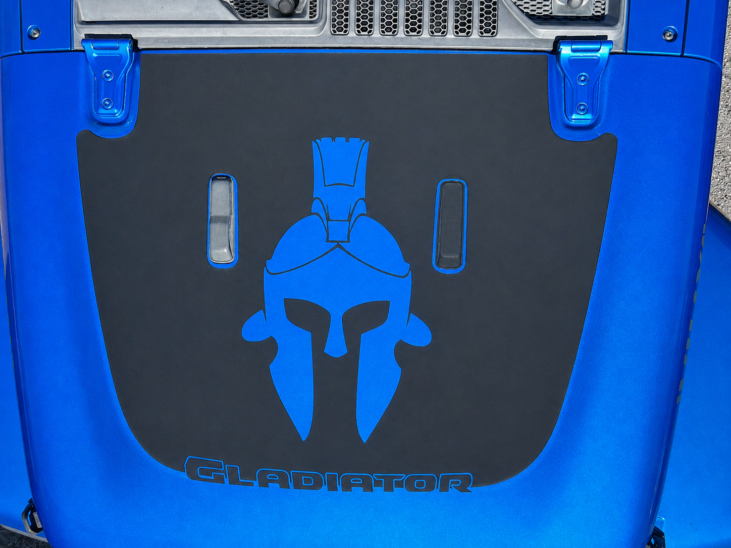 Gladiator Spartan helmet blackout hood decal installed on blue Jeep Gladiator JT truck hood