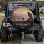 Grand Canyon National Park spare tire cover on a Jeep Wrangler, showing a California condor on the rim above layered canyon walls