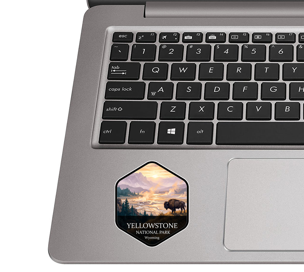 Yellowstone National Park badge sticker applied to the palm rest of a silver laptop